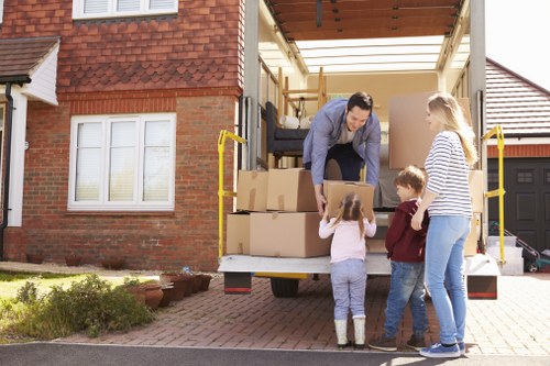Professional movers carrying items through a Pimlico building