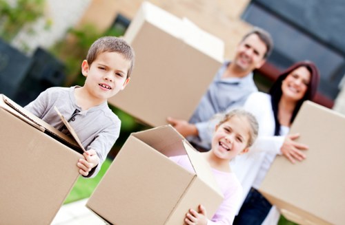 Removalists carrying furniture through a Pimlico residential building