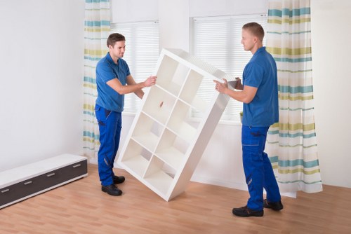 Furniture and packed belongings being loaded into a moving van