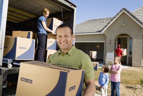 Packed household boxes and protected furniture ready for transport